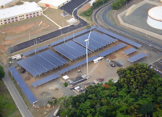 The Army leverages private sector expertise through Energy Savings Performance Contracts and Utility Energy Service Contracts to improve efficiency and contribute to resilience. Solar PV parking canopies and two wind turbines, installed as part of an ESPC at Fort Buchanan, Puerto Rico, produce approximately 5.5 MW of renewable energy. (U.S. Army)