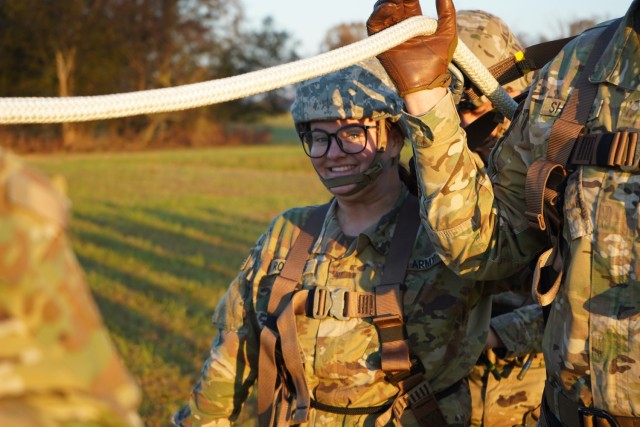 Private 2nd Class Melanie Rollings, a U.S. Army culinary specialist (92G) in the 101st Airborne Division (Air Assault) from Fort Wayne, Indiana, smiles in her harness as she prepares to be lifted on a rope with nine other Soldiers during Operation LETHAL EAGLE on Fort Campbell, Kentucky. Operation LETHAL EAGLE is a 21-day, division-wide field training exercise. A tactic used for inserting or extracting Soldiers in areas where a helicopter landing zone cannot be established is commonly referred to as SPIES, Special Patrol Insertion Extraction System.