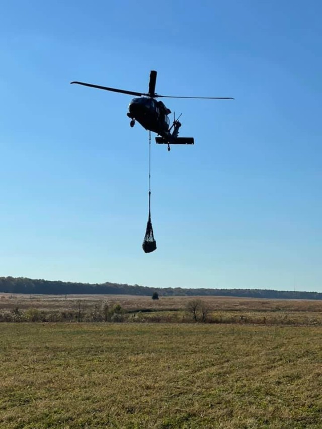 A UH-60 helicopter carries a sling load of food supplies to be distributed to units from the 2nd Brigade Combat Team, 101st Airborne Division (Air Assault), during the Division Training Density at Fort Campbell, Ky., November 7, 2021. The sling load operations was conducted by Soldiers from Alpha Company, 526th Brigade Support Battalion, 2nd Brigade Combat Team, 101st Airborne Division (Air Assault). (Courtesy photo)