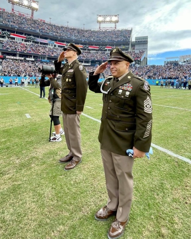 Blanchfield Army Community Hospital Command Team Col. Vincent B. Myers and Command Sgt. Maj. Daniel Santiago salute as Soldiers from BACH, Soldier Recovery Unit, 531st Hospital Center, Fort Campbell Dental Activity and Fort Campbell Veterinary Center unfurl a 120-foot long U.S. flag before the start of an NFL football game between the Tennessee Titans and New Orleans Saints, Nov. 14, at Nissan Stadium in Nashville, Tennessee. More than 80 Soldiers were invited by the Tennessee Titans to participate in the pregame ceremonies honoring the nation’s Veterans.
