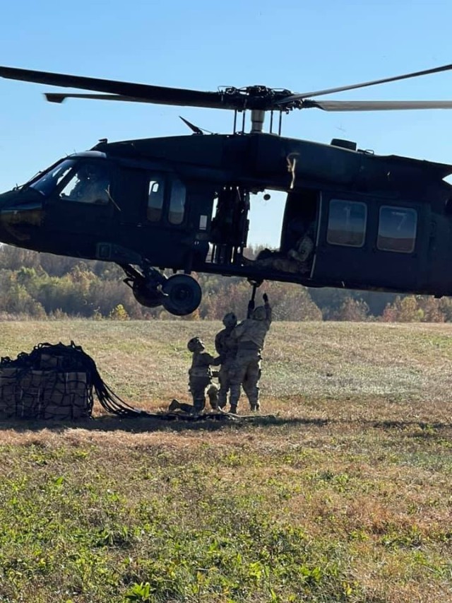 Soldiers from Alpha Company, 526th Brigade Support Battalion, 2nd Brigade Combat Team, 101st Airborne Division (Air Assault) hook up a sling load onto a UH-60 Blackhawk during the Division Training Density to resupply their sister units at Fort...