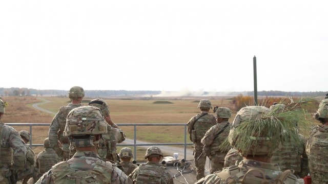 Senior officers and non-commissioned officers observe artillery fires drop onto fighting positions off in the distance from a rooftop as part of the leadership professional development event during Operation Lethal Eagle, November 10, 2021, Fort Campbell, KY. (U.S. Army Photo by Sfc. Jedhel Somera, 40th Public Affairs Detachment)