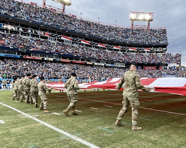 Soldiers from Blanchfield Army Community Hospital, Soldier Recovery Unit, Fort Campbell Dental Activity, Fort Campbell Veterinary Center and 531st Hospital Center unfurl a U.S. flag during Tennessee Titans and New Orleans Saints pregame ceremonies at Nissan Stadium, Nashville, Tennessee, Nov. 14. Leaders from the 101st Airborne Division (Air Assault) extended the opportunity to medical units at Fort Campbell to represent the division during the Tennessee Titans Salute to Service event honoring veterans.