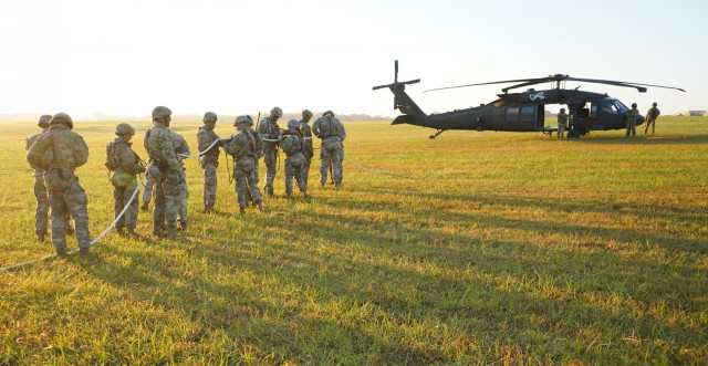 Ten Soldiers prepare to be lifted off the ground on a rope by a UH-60 Blackhawk during, Special Patrol Insertion Extraction System (SPIES), training. SPIES is an air assault tactic used for inserting or extracting Soldiers in areas where a helicopter landing zone cannot be established. Instructors from the Sabalauski Air Assault School and pilots from C Company, 5th Battalion, 101st Combat Aviation Brigade provided SPIES and Landing Zone/Pick Up Zone training for every battalion in the division during Operation LETHAL EAGLE. Operation LETHAL EAGLE is a 21-day, division-wide field training exercise.