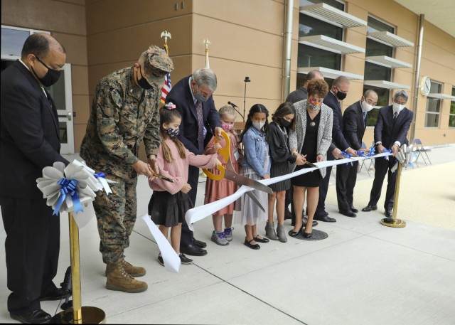 Japan Engineer District, U.S. Army Corps of Engineers employees cut the ribbon during an official ribbon-cutting ceremony for Edward C. Killin Elementary Nov. 10, 2021 on Camp Foster, Okinawa, Japan. The district joined representatives from...