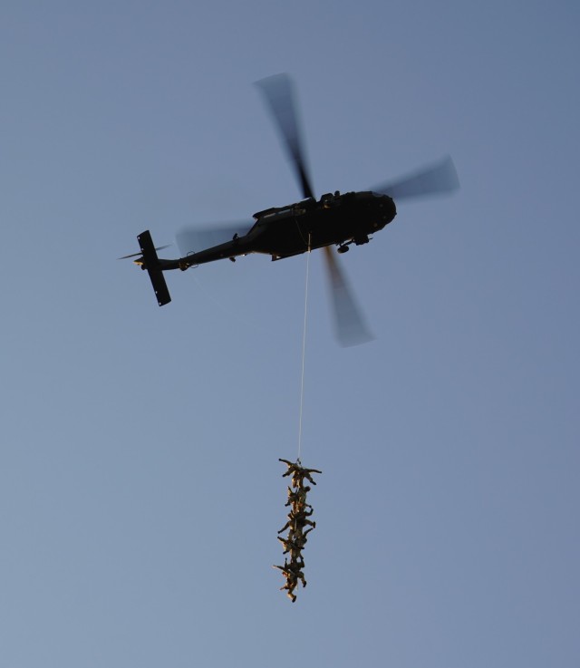 A helicopter lifts ten Soldiers from the ground during Special Patrol Insertion Extraction System (SPIES) training. SPIES is an air assault tactic used for inserting or extracting Soldiers in areas where a helicopter landing zone cannot be established. Instructors from the Sabalauski Air Assault School and pilots from the 101st Combat Aviation Brigade provided SPIES and Landing Zone/Pick Up Zone training for every battalion in the division during Operation LETHAL EAGLE. Operation LETHAL EAGLE is a 21-day, division-wide field training exercise.