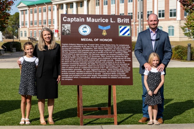 The Family of Capt. Maurice Britt poses for a photo after the unveiling of the dedication plaque during the gate dedication ceremony for Capt. Maurice Britt, Capt. Jesse Wooldridge and Cpl. Hiroshi Miyamura on Nov. 18, 2021, on Fort Stewart, Georgia. During Marne Week, the dedication of the installation gates were named to honor the Dogface Soldiers and to inspire others to emulate their example.(U.S. Army photo by Pfc. Elsi Delgado)