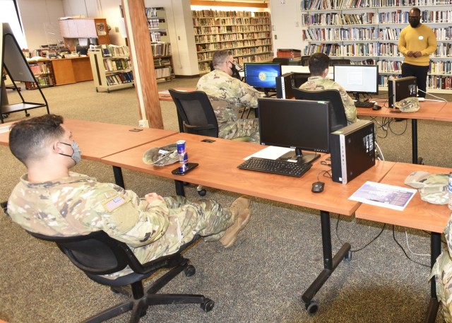 Richard Amponsah, a Truman Education Center counselor, walks Soldiers through the process of setting up an ArmyIgnitED account during a lunchtime information session held in celebration of American Education Week. Soldiers use ArmyIgnitED, which...