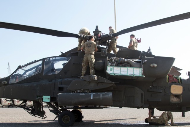 Soldiers assigned to the Fort Bragg, North Carolina, based 82nd Aviation Combat Brigade, 82nd Airborne Division, prepare an AH-64E Apache helicopter for retrograde operations at the Port of Shuaiba, Kuwait, Nov. 10, 2021. The Aberdeen Proving Ground, Maryland, based 1100th Theater Aviation Sustainment Maintenance Group oversaw the preparations for the retrograde—which included completing engine rinses and washes and folding the rotor blades—of more than 30 aircraft assigned to the 82nd CAB from Nov. 7-12. The Soldiers and aircraft were deployed to Afghanistan to support base closures and the U.S. military’s exit from the Hamid Karzai International Airport in Kabul.