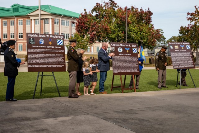 U.S. Army Soldiers of the 3rd Infantry Division and Family of Capt. Maurice Britt unveil the new plaques marking the renaming of gates one, three and five for Capt. Maurice Britt, Capt. Jesse Wooldridge and Cpl. Hiroshi Miyamura as part of Marne Week, on Fort Stewart, Georgia, Nov. 18, 2021. During Marne Week, the dedication of the installation gates were named to honor the Dogface Soldiers and to inspire others to emulate their example.(U.S. Army photo by Pfc. Elsi Delgado)