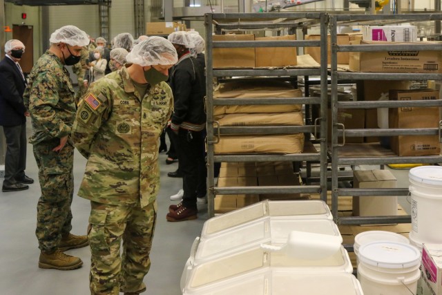 Command Sgt. Maj. Robert Cobb, Eighth Army senior enlisted advisor, looks at baking ingredients during a tour of the new Army and Air Force Exchange Service Korea Distribution Center and bakery on U.S. Army Garrison Humphreys, South Korea, Nov....