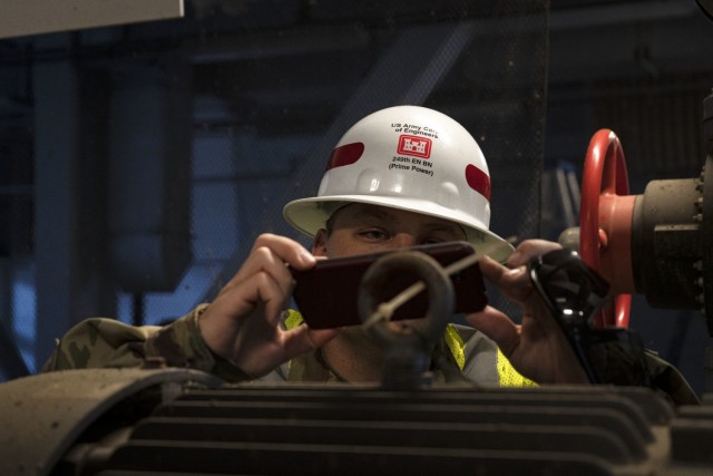 U.S. Army Staff Sgt. Matthew Bradford, 249th Engineer Battalion Charlie Company Prime Power production specialist, photographs facility data during Exercise Empire Rising 2021 at the Washington Aqueduct in Washington D.C., July 14, 2021. Also...