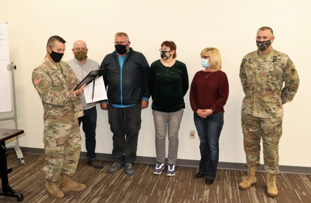 Deputy Garrison Commander Lt. Col. Chad Maynard reads an appreciation certificate Nov. 4, 2021, in the Installation Emergency Operations Center at Fort McCoy, Wis. The certificate, signed by the Fort McCoy Garrison Commander Col. Michael Poss...