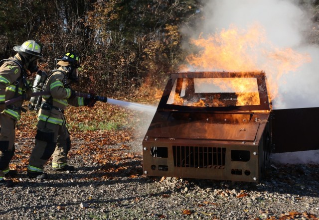 A Fort Knox Middle High School student works to extinguish the flames in a practice car fire Nov. 19, 2021 during unique training as part of a yearlong certification course.
