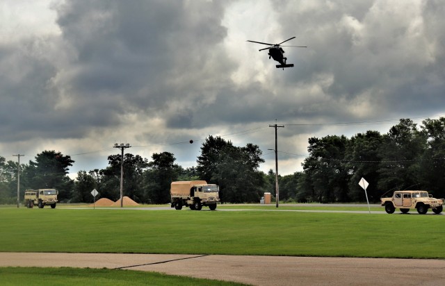 A UH-60 Black Hawk helicopter flies overhead and other training operations are shown July 15, 2021, at Fort McCoy, Wis., for the Army Forces Command Exercise Pershing Strike ’21. Thousands of military members trained at Fort McCoy in the...