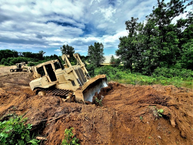 Spc. Seth Abbot with the Wisconsin National Guard's 950th Engineering Company (Route Clearance) operates a bulldozer at a training area July 12, 2021, at Fort McCoy, Wis. The work is part of a troop project coordinated by the Fort McCoy...
