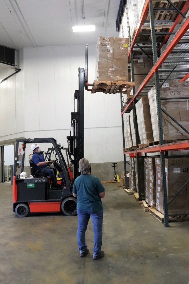 Supply Specialist Tamra Meyer with the Fort McCoy Logistics Readiness Center (LRC) Food Program Management Office (right) prepares to check food content on a pallet Oct. 14, 2021, during food service operations at the LRC Supply Subsistence...