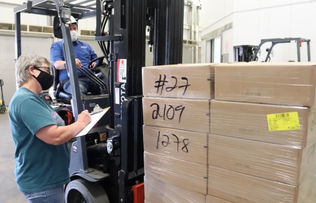 Supply Specialist Tamra Meyer with the Fort McCoy Logistics Readiness Center (LRC) Food Program Management Office (right) prepares to check food content on a pallet Oct. 14, 2021, during food service operations at the LRC Supply Subsistence...