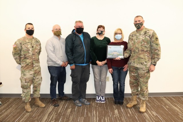 Deputy Garrison Commander Lt. Col. Chad Maynard (left) and Fort McCoy Garrison Commander Col. Michael Poss (right) present an appreciation certificate Nov. 4, 2021, in the Installation Emergency Operations Center at Fort McCoy, Wis. The...