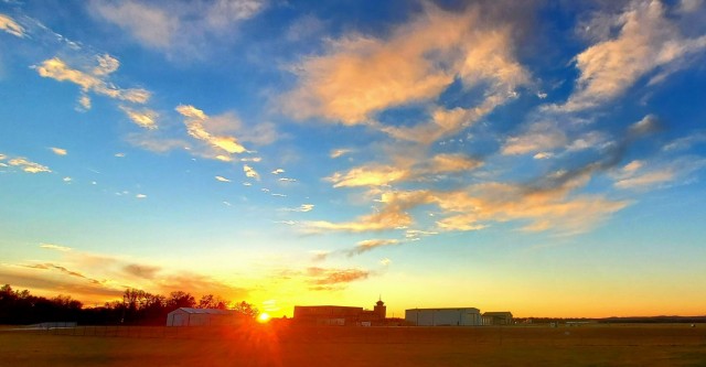 The sun sets behind airport buildings Nov. 9, 2021, at Sparta-Fort McCoy Airport at Fort McCoy, Wis. The airport is often one of the best open areas to catch a colorful sky scene at the installation. Learn more about Fort McCoy online at...