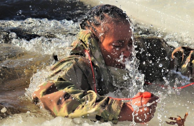 A Fort McCoy Cold-Weather Operations Course (CWOC) Class 21-04 student participates in cold-water immersion training Feb. 26, 2021, at Big Sandy Lake on South Post at Fort McCoy, Wis. CWOC students are trained on a variety of cold-weather...