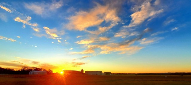 The sun sets behind airport buildings Nov. 9, 2021, at Sparta-Fort McCoy Airport at Fort McCoy, Wis. The airport is often one of the best open areas to catch a colorful sky scene at the installation. Learn more about Fort McCoy online at...