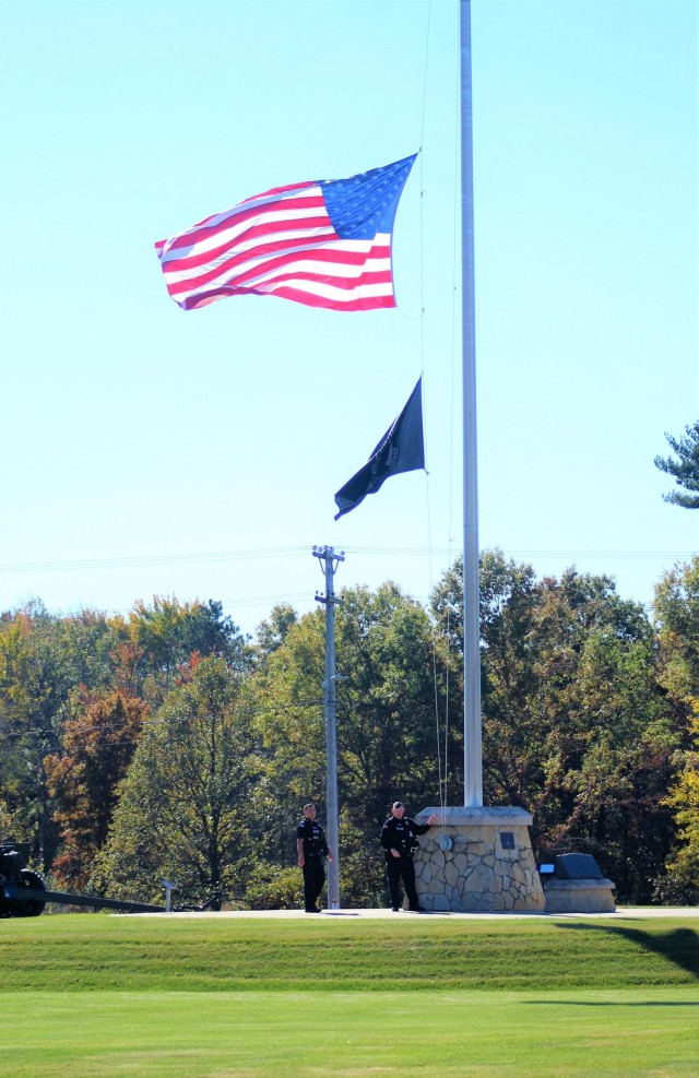 Officers with the Directorate of Emergency Services Police Department finish setting the U.S. flag at half-staff Oct. 18, 2021, at Fort McCoy in honor of Army Gen. Colin Powell, who recently died at the age of 84. Powell was the chairman of the Joint Chiefs of Staff during Operation Desert Storm in 1991 and also served four years as the U.S. Secretary of State in the early 2000s. (U.S. Army Photo by Scott T. Sturkol, Public Affairs Office, Fort McCoy, Wis.)