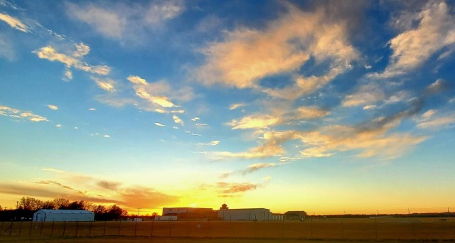 The sun sets behind airport buildings Nov. 9, 2021, at Sparta-Fort McCoy Airport at Fort McCoy, Wis. The airport is often one of the best open areas to catch a colorful sky scene at the installation. Learn more about Fort McCoy online at...