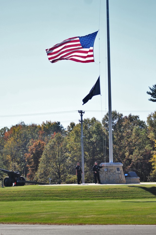 Officers with the Directorate of Emergency Services Police Department finish setting the U.S. flag at half-staff Oct. 18, 2021, at Fort McCoy, Wis., in honor of Army Gen. Colin Powell, who recently died at the age of 84. Powell was the chairman of the Joint Chiefs of Staff during Operation Desert Storm in 1991 and also served four years as the U.S. Secretary of State in the early 2000s. (U.S. Army Photo by Scott T. Sturkol, Public Affairs Office, Fort McCoy, Wis.)