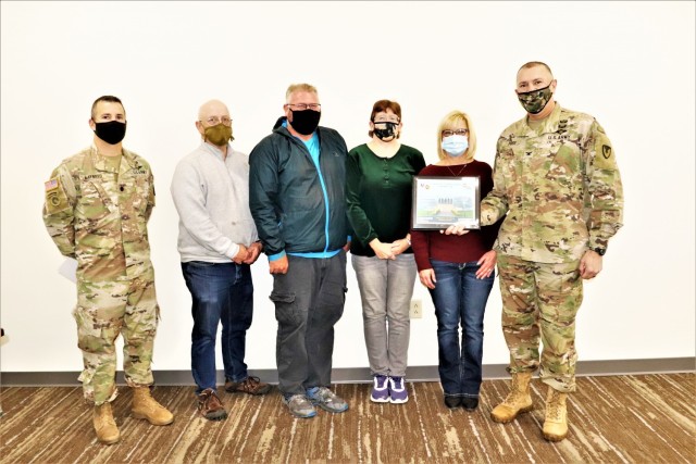 Deputy Garrison Commander Lt. Col. Chad Maynard (left) and Fort McCoy Garrison Commander Col. Michael Poss (right) present an appreciation certificate Nov. 4, 2021, in the Installation Emergency Operations Center at Fort McCoy, Wis. The...