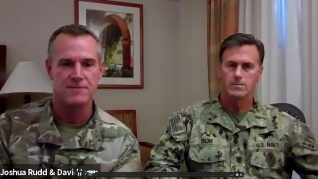 Left, Maj. Gen. Joshua Rudd, Special Operations Command-Pacific commander, and right, and Command Master Chief Petty Officer David Isom, discuss how Soldiers and U.S. service members can better care for themselves and boost readiness.