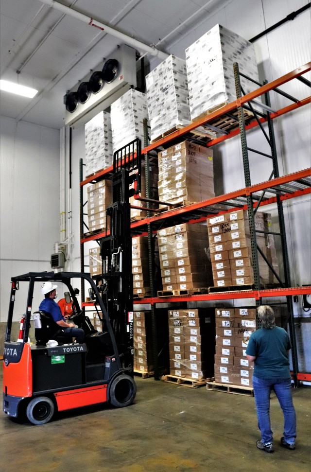 Supply Specialist Tamra Meyer with the Fort McCoy Logistics Readiness Center (LRC) Food Program Management Office (right) prepares to check food content on a pallet Oct. 14, 2021, during food service operations at the LRC Supply Subsistence...