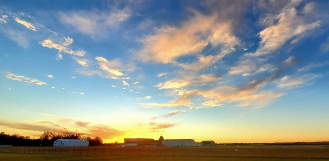 The sun sets behind airport buildings Nov. 9, 2021, at Sparta-Fort McCoy Airport at Fort McCoy, Wis. The airport is often one of the best open areas to catch a colorful sky scene at the installation. Learn more about Fort McCoy online at...
