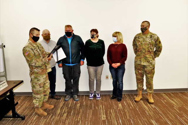 Deputy Garrison Commander Lt. Col. Chad Maynard reads an appreciation certificate Nov. 4, 2021, in the Installation Emergency Operations Center at Fort McCoy, Wis. The certificate, signed by the Fort McCoy Garrison Commander Col. Michael Poss...