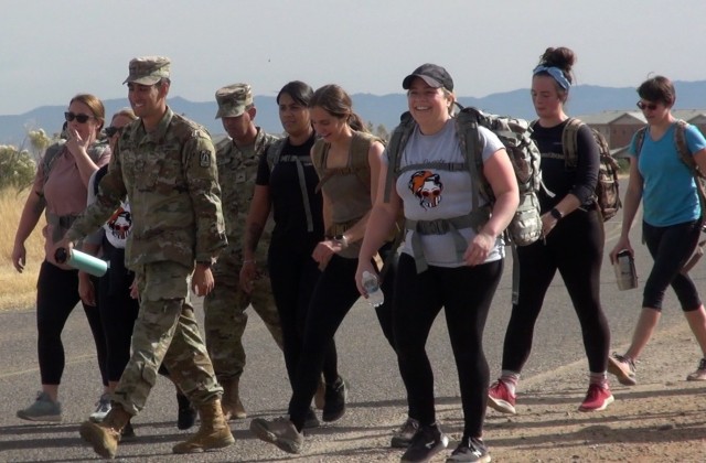 Spouses and Soldiers set off on a ruck march during Combat Spouses Day giving the Army Spouses a glimpse of what their Soldier experiences.