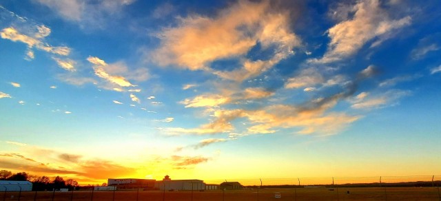The sun sets behind airport buildings Nov. 9, 2021, at Sparta-Fort McCoy Airport at Fort McCoy, Wis. The airport is often one of the best open areas to catch a colorful sky scene at the installation. Learn more about Fort McCoy online at...