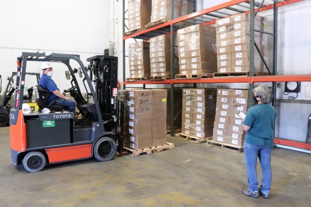 Supply Specialist Tamra Meyer with the Fort McCoy Logistics Readiness Center (LRC) Food Program Management Office (right) prepares to check food content on a pallet Oct. 14, 2021, during food service operations at the LRC Supply Subsistence...