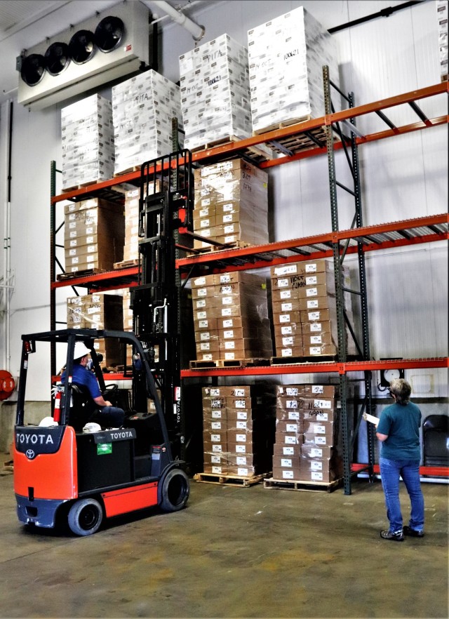 Supply Specialist Tamra Meyer with the Fort McCoy Logistics Readiness Center (LRC) Food Program Management Office (right) prepares to check food content on a pallet Oct. 14, 2021, during food service operations at the LRC Supply Subsistence...