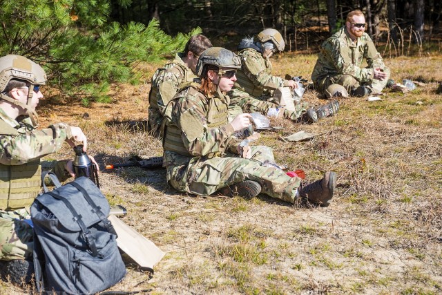 Civilian employees from the U.S. Army Combat Capabilities Development Command Soldier Center eat MREs in the field at Fort Devens, Massachusetts during a Greening training session held November 1-5, 2021.