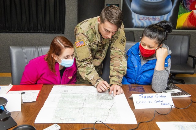 Sgt. Justin Hey, an infantryman from B Company, 1st Battalion, 325th Airborne Infantry Regiment, teaches land navigation to civilian employees from the U.S. Army Combat Capabilities Development Command Soldier Center during a classroom day as part of the center’s revamped Greening training, held November 1-5, 2021 at Natick Soldier Systems Center, in Massachusetts.