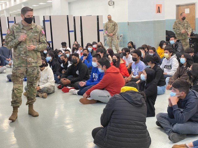 Col. Craig Martin, Fort Hamilton Garrison Commander speaks with local Junior Reserve Officer's Training cadets at Fort Hamilton High School, N.Y., Nov. 22, 2021. The leadership team engaged with approximately 120 JROTC students to connect and acknowledge their efforts and commitment to excellence.