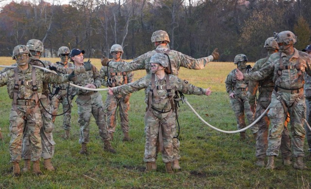 Pvt. 2nd Class Melanie Rollings (center), Col. John Lubas (left), and Staff Sgt. Andrew Tuitama (right), receive training on Special Patrol Insertion Extraction System (SPIES). SPIES is an air assault tactic used for inserting or extracting Soldiers in areas where a helicopter landing zone cannot be established. Instructors from the Sabalauski Air Assault School and pilots from the 101st Combat Aviation Brigade provided SPIES and Landing Zone/Pick Up Zone training for every battalion in the division during Operation LETHAL EAGLE. Operation LETHAL EAGLE is a 21-day, division-wide field training exercise.