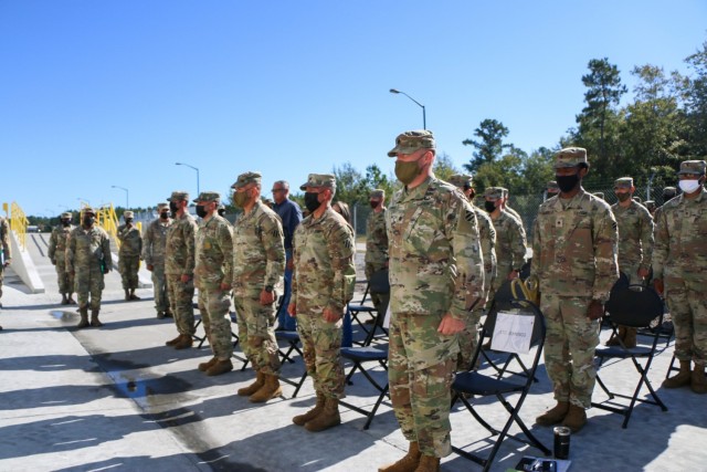 Soldiers assigned to the "Maintain Battalion," 703rd Brigade Support Battalion, 2nd Armor Brigade Combat Team, 3rd Infantry Division, stand at attention during the playing of the Dogface Soldier song for the opening ceremony of 2nd ABCT supply support activity facility at Fort Stewart, Georgia, Nov. 9, 2021. The new SSA facility brings to bear modernized systems and processes to provide all items necessary to equip, maintain and sustain 2nd ABCT's modernization and supports the Division's glide path to become the most modernized division in the U.S. Army by summer of 2023. (U.S. Army photo by Sgt. Trenton Lowery)