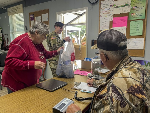 Volunteers at the Nolanville Food Pantry weigh non perishable donations, Nolanville, Texas, Nov. 19, 2021. The Pantry accepted donations through the evening time and raised over 10,000 lbs in one day. (U.S. Army photo by Sgt. Melissa N. Lessard)