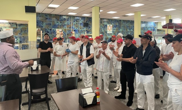 Jerome Young, the installation food service program manager for Logistics Readiness Center Ansbach, (far left) praises the food service staff at the Katterbach Warrior Restaurant. The LRC Ansbach food service program Young manages includes two...
