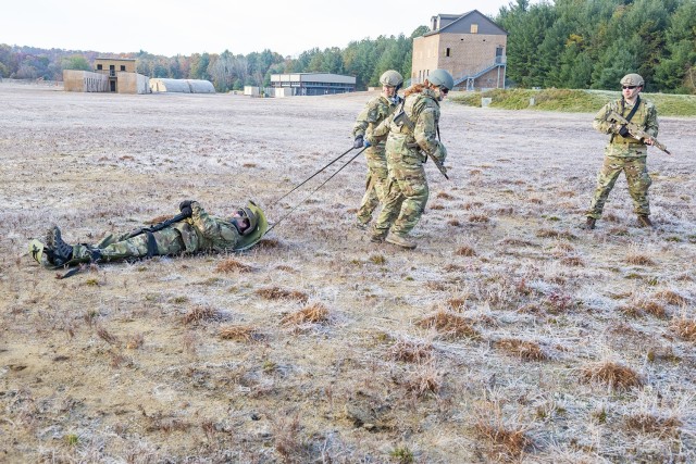 Civilian employees from the U.S. Army Combat Capabilities Development Command Soldier Center conduct casualty evacuations using a Skedco litter in the field during the center’s Greening training held November 1-5, 2021, at Fort Devens, Massachusetts.