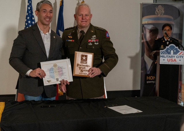 U.S. Army North Commanding General Lt. Gen. John R. Evans, Jr., right, presents the city of San Antonio Mayor Ron Nirenberg, left, with a certificate of participation and plaque to the city of San Antonio on behalf of the U.S. Army PaYS Program at the Plaza de Armas Gallery, San Antonio, Texas, Nov. 19, 2021. The U.S. Army PaYS Program guarantees Soldiers and ROTC cadets five job interviews and possible employment with the city of San Antonio government after their service in the U.S. Army.