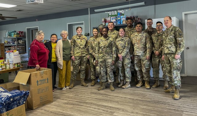 Soldiers with 504th Expeditionary Military Intelligence Brigade pose for a photo, Nolanville, Texas, Nov. 19, 2021. The unit doated 3,414 lbs. of non perishable foods to the local food pantry. (U.S. Army Photo by Sgt. Melissa N. Lessard)