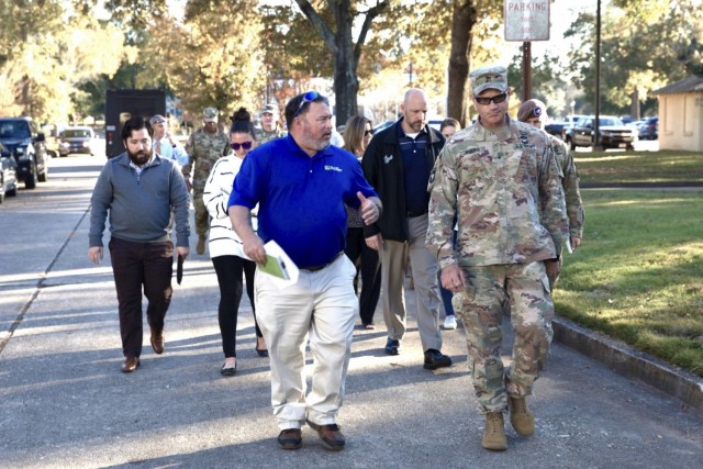 Brig. Gen. Larry Q. Burris, U.S. Army Infantry School Commandant, Maneuver Center of Excellence, leads housing officials and leaders from Fort Benning post directorates, during a walking town hall historic East Main Post II. 