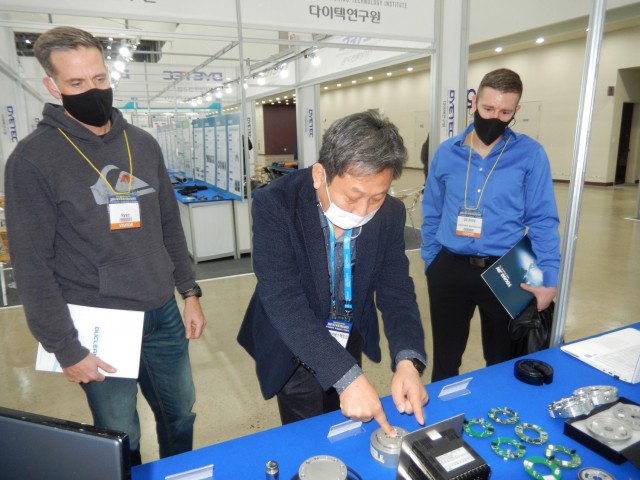 A vendor demonstrates a pressure sensing device for Chief Warrant Officer 3, Ryan Chaney, senior ground maintenance warrant officer, Support Operations (left), and Capt. Chris Benson, Current Operations officer in charge, Operations, at the Daegu...